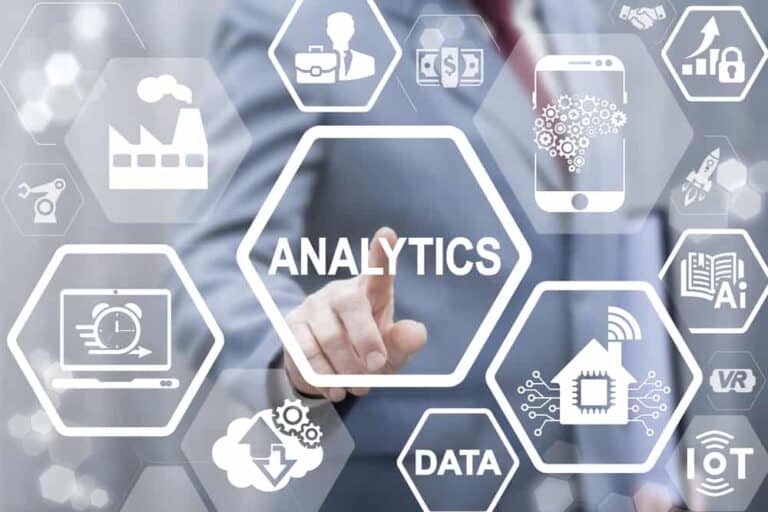A man in a business suit is pointing at an analytics icon.